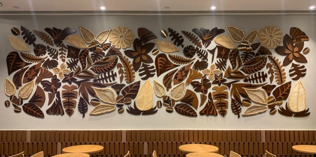 Wall-mounted coffee-botanical installation in cane, wood and gold at Starbucks HiLITE Mall, Kozhikode